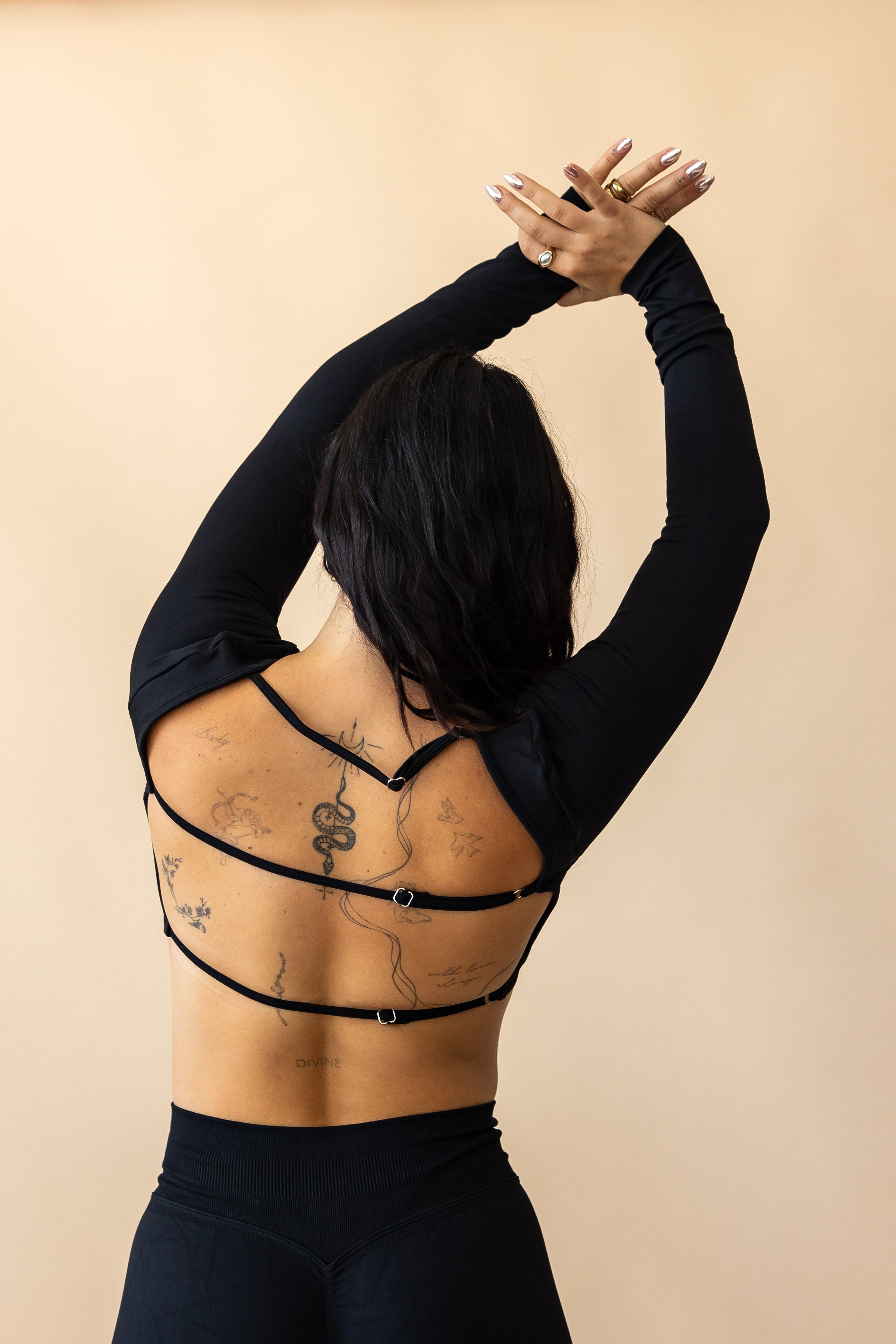 Woman wearing black backless workout top 